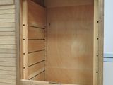 a wooden cabinet with a door open on the floor