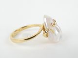 a close up of a gold ring with a white pearl in it