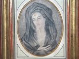 an old picture of a woman with a veil in a gold frame