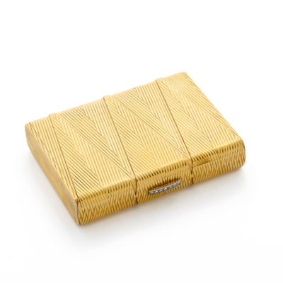 yellow gold cigarette case on a white surface with a white background