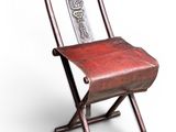 chair made of wood and metal with a red leather seat