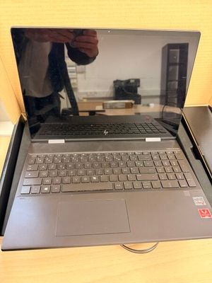 a laptop computer sitting on a table with a person taking a picture