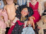 a lot of dolls that are sitting together on a table
