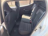 the back seats of a white car with a black seat belt