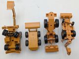 four toy vehicles that are sitting next to each other