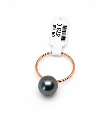 a close up of a ring with a black pearl on it
