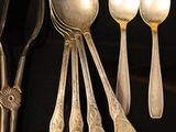a lot of silver spoons and spoon spoons on a table