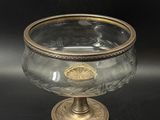 an image of a glass bowl with a gold rim on a black background
