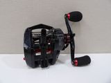a close up of a fishing reel on a white surface