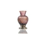 a pink glass vase sitting on top of a table