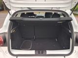 a trunk of a white car with its doors open