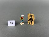 toy figurine of a cowboy standing next to a sign with the number 15
