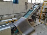 an image of a conveyor belt in a warehouse with boxes on the floor