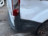 a white van that has been vandalized and is parked in a parking lot