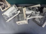 several old black and white photos of people and buildings on a table
