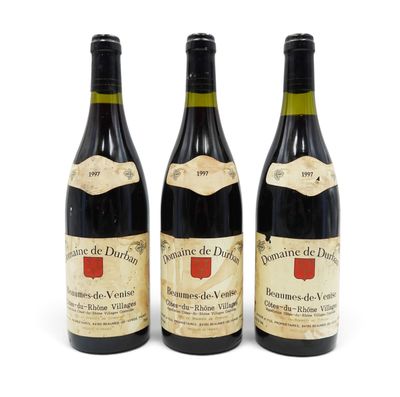 three bottles of wine are lined up on a white surface
