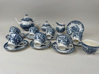 blue and white porcelain tea set with teapots, cups, saucers and spoons