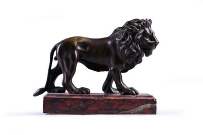 statue of a lion on a marble base on a white background