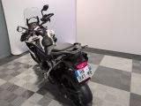 a motorcycle that is parked in a room with a checkered floor