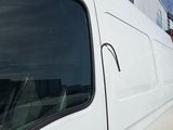 a white van that is parked on the side of the road