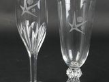 two wine glasses sitting next to each other on a table
