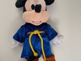 mickey mouse dressed as a wizard with a blue hat and blue robe