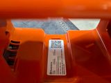 a close up of an orange blower with a label on it
