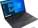the laptop is open on a white surface with windows on the screen