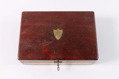 a small wooden box with a gold heart on it