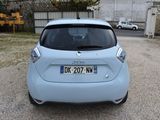 a small blue car parked in a parking lot
