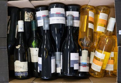 many bottles of wine in a box on the table