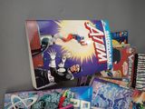 many comic books on a table with a gray background