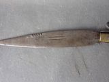 a knife that is laying on a table