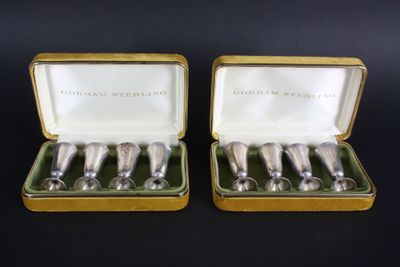 a pair of silver spoons in a gold case