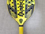 a close up of a tennis racket on a gray surface