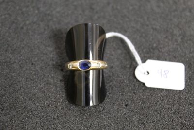 a silver ring with a blue stone on top of it