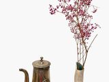 flowers in a vase next to a teapot and a tea kettle on a white surface