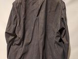 the back of a jacket hanging on a hanger on a wall
