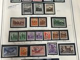 an open book with a bunch of stamps on it sitting on top of a table