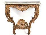 an ornately carved console table with marble top