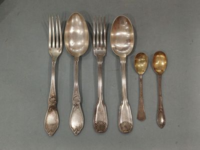 five spoons and two spoons sitting on a table
