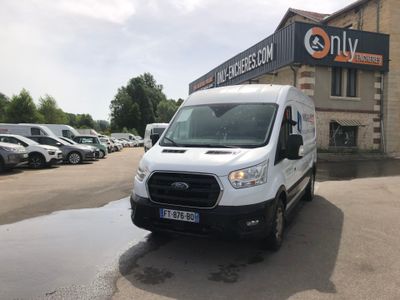 a white van that is parked in front of a building