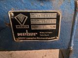a close up of a metal sign on a blue machine