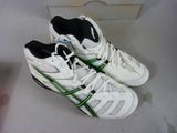 pair of white and green tennis shoes on display in a box