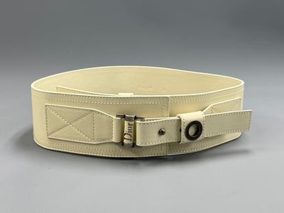 a close up of a white belt with a buckle on it