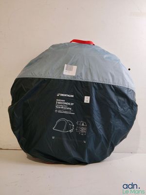 a black and blue bag with a red handle sitting on a white surface