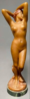 statue of a nude woman holding her hands up to her head
