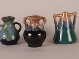 three vases sitting next to each other on a table