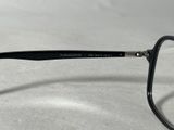 black glasses with clear lenses sitting on a white surface