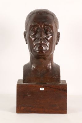 an image of a bronze bust of a man on a wooden base